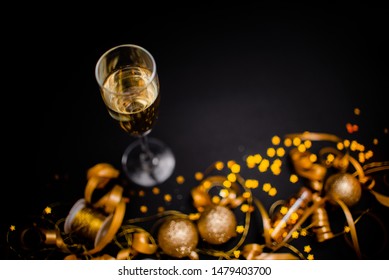 Gllasses Of Champagne On Black Stylish Background With Place For Text. Festive Concept.Golden Stylish Decoration On Black Background.  Sticky Tape, Christmas Balls, Golden Ribbon