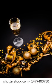 Gllasses Of Champagne On Black Stylish Background With Place For Text. Festive Concept.Golden Stylish Decoration On Black Background.  Sticky Tape, Christmas Balls, Golden Ribbon