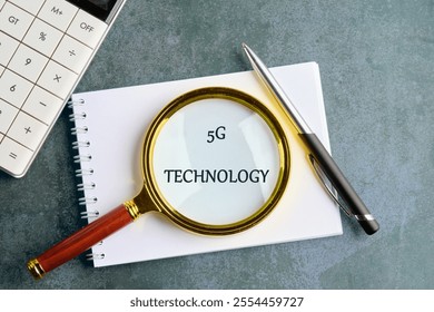 Global business, finances, computing and data processing concept. 5G TECHNOLOGY in a clean notebook on a gray background, top view.
