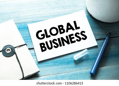Global Business text concept, wooden background