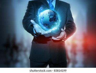 Global Communication - A businessman holding a glowing, connected, World.