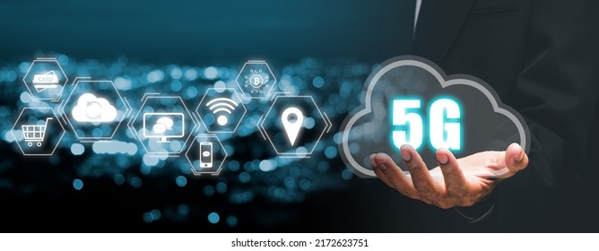 Global Communication Network Concept, Person Hand Holding 5G Icon On Virtual Screen With City Scape Background, World Wide Business, High-speed Mobile Internet, New Generation Networks. Mixed Media.