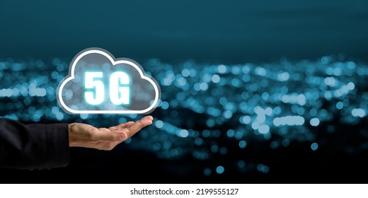 Global Communication Network Concept, Person Hand Holding 5G Icon On Virtual Screen With City Scape Background, World Wide Business, High-speed Mobile Internet, New Generation Networks. Mixed Media. 