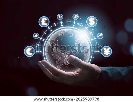 Global currency exchange concept, Businessman holding world with virtual line effect and dollar yuan yen euro and pound sterling sign.
