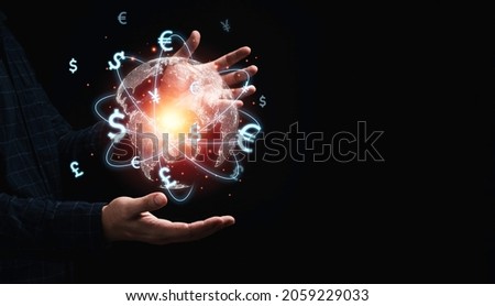Global currency exchange concept, Trader holding world with virtual line effect and dollar yuan yen euro and pound sterling sign.