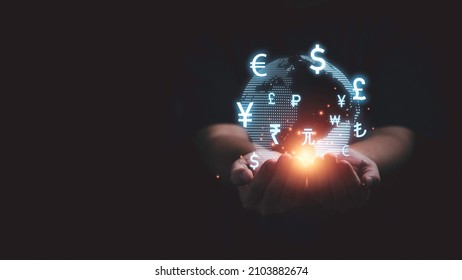 Global currency exchange and forex concept, Business man hand holding world with virtual line effect and dollar yuan yen euro and pound sterling sign with copy space. - Shutterstock ID 2103882674