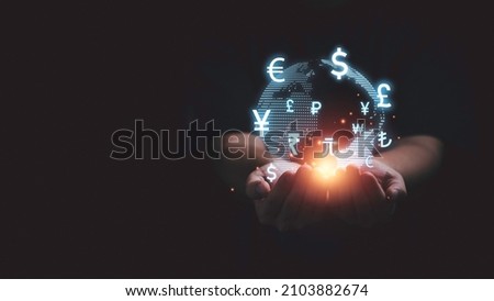 Global currency exchange and forex concept, Business man hand holding world with virtual line effect and dollar yuan yen euro and pound sterling sign with copy space.