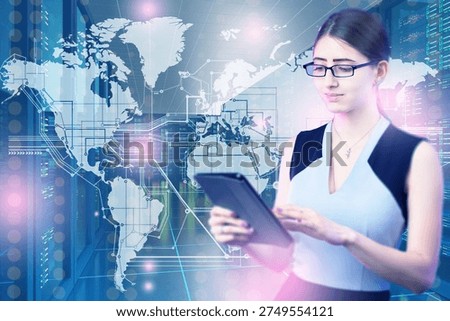 Global data analytics, IT infrastructure. Data analyst uses tablet while monitoring worldwide network connections and server systems inside modern data center.