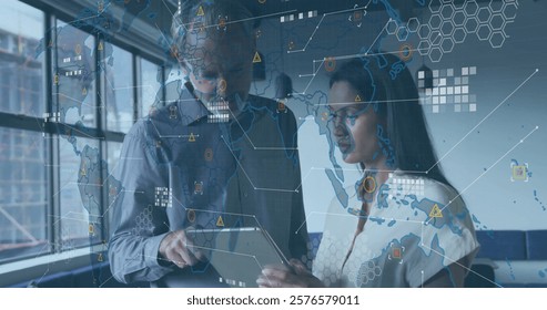Global data network image over business professionals discussing information on tablet. Technology, communication, teamwork, collaboration, innovation, connectivity