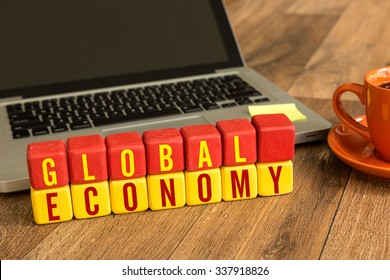 Global Economy Written On A Wooden Cube In Office Desk