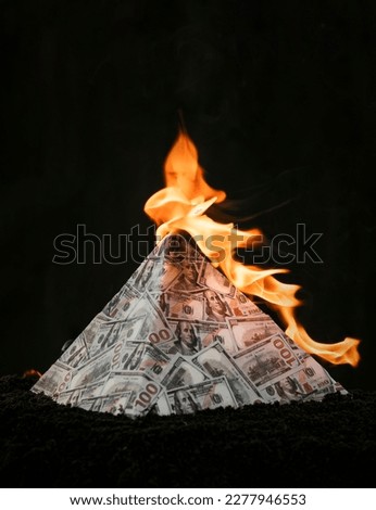 A global financial pyramid based on the dominance of the dollar. World management concept. conspiracy theory. the collapse of the dollar's financial system. Money is burning on a dark background.
