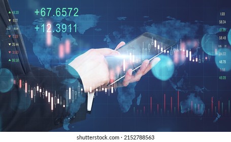 Global investing trading concept with businessman hand using digital tablet and virtual interface screen with forex chart indicators, candlesticks, and world map.
