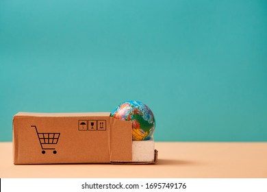 Global Logistic And Transportation. International Delivery Service. Cargo Shipping. Cardboard Box And Globe Miniature