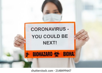 Its a global problem calling for a global response. Shot of a woman holding up a sign saying CORONAVIRUS - YOU COULD BE NEXT.