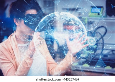 Global technology background in blue against female graphic designer using the virtual reality headset - Powered by Shutterstock