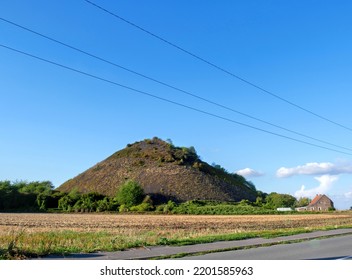 Global View Of A Slag Heap In Northern France, Under A Blue Sky.