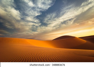 Global warming concept. Lonely sand dunes under dramatic evening sunset sky at drought  desert landscape - Shutterstock ID 348883676