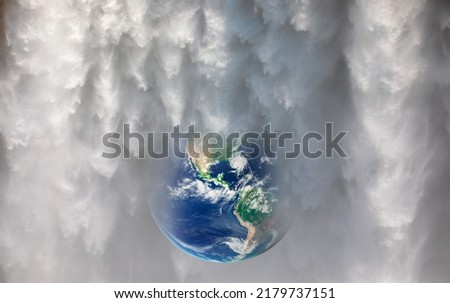 Global warming concept - Planet earth in the waters of waterfalls 
