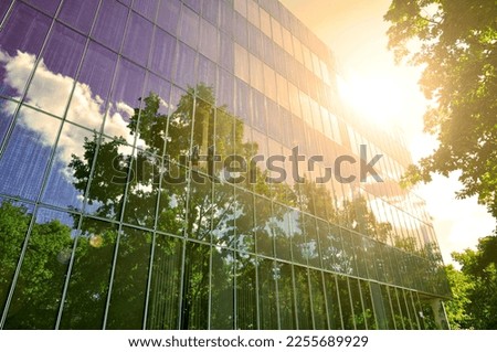 Global warming in urban environment hot weather and climate change in city building sun sunshine light reflection on a glass wall facade
