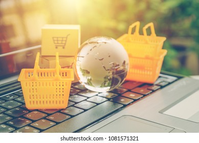 Global Or Worldwide Online Shopping / Retail Ecommerce And Delivery Service Concept : Baskets, A Globe Map On A Laptop, Depicts Consumers Purchase Or Order Products From Suppliers Or Digital Stores.