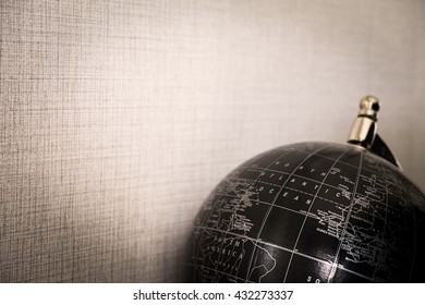 Globe black on brown background