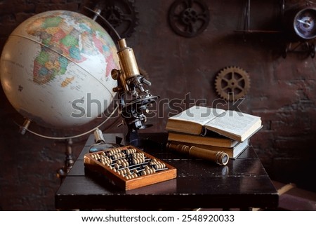 Globe, brass microscope, abacus, and open books on a wooden desk with a vintage background, symbolizing science and history