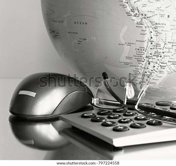 globe with calculator and mouse in office area\
stock photo