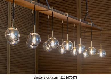 Globe Glass Pendant Light Chandelier In Antique Brass Finish With Wooden Cladding Background