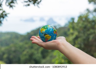 Globe in hand. The whole world in your hands. Protect the world from war and disaster.