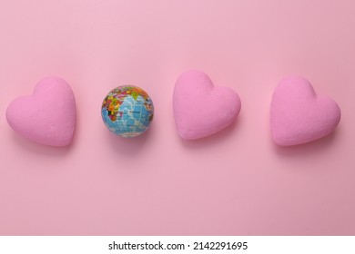 Globe With Hearts On Pink Background. Love Concept. Top View