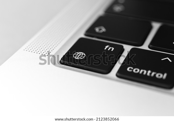 The\
globe key and button on keyboard. The globe and language settings\
sign close-up. Modern laptop, communication\
concept