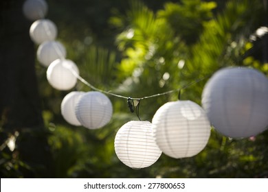 Globe Lanterns Hanging On A String At A Party