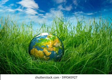 Globe lies on green grass. Concept - Earth Day. - Shutterstock ID 599345927