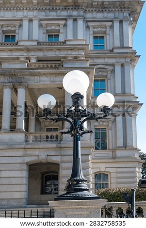 Globe lights frame classical columns on the Eisenhower Executive Office Building.