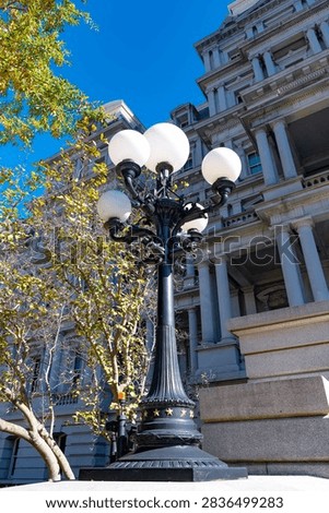 Globe lights frame classical columns on the Eisenhower Executive Office Building.