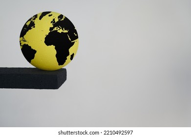 Globe With Map Of The World Dangerously Approaching The Edge Of The Abyss. Concept Of Global Collapse