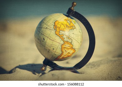 Globe On The Beach, Aged And Worn Vintage Style Photo