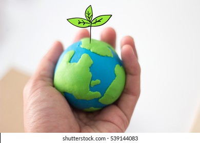 Globe On Hand With Plant, Safe The World , CSR Abbreviation Or Corporate Social Responsibility Concept