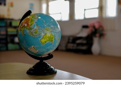 globe on the table with a blurred background