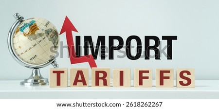 A globe is on a table with the word Import Tariffs written below it. Concept of international trade and the importance of tariffs in regulating it