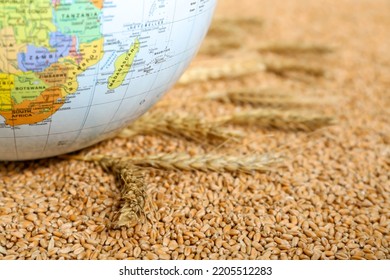 Globe On Wheat Grains, Closeup. Hunger Crisis Concept