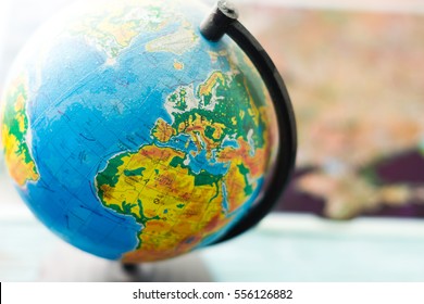 Globe political map of the world on a blurred background. - Shutterstock ID 556126882