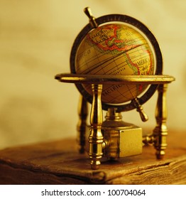 Globe standing on a vintage book.