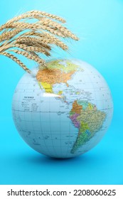 Globe With Wheat Spikelets On Turquoise Background. Hunger Crisis Concept