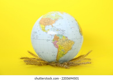 Globe With Wheat Spikelets On Yellow Background. Hunger Crisis Concept