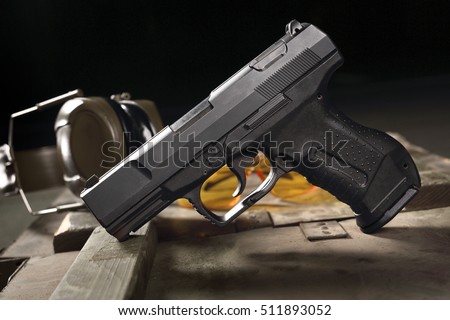 Glock pistol, sharp weapon. Glock pistol, cartridges and headphones protect ears