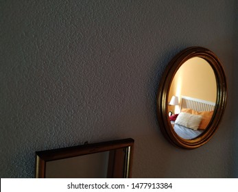 Glod morror with bedroom reflection