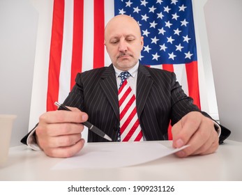 Gloomy American Writes Something. Adult Man On Phone Of American Flag. Concept - Civil Servant At Work. Working For US Government. Work For US State Government. American Civil Servant.