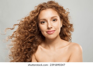 Glorious young fashion model woman with natural makeup, clear skin and curly hairstyleposing on white background - Powered by Shutterstock