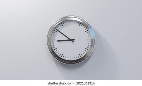 Glossy chrome clock on a white wall at fifty-one past eight. Time is 08:51 or 20:51